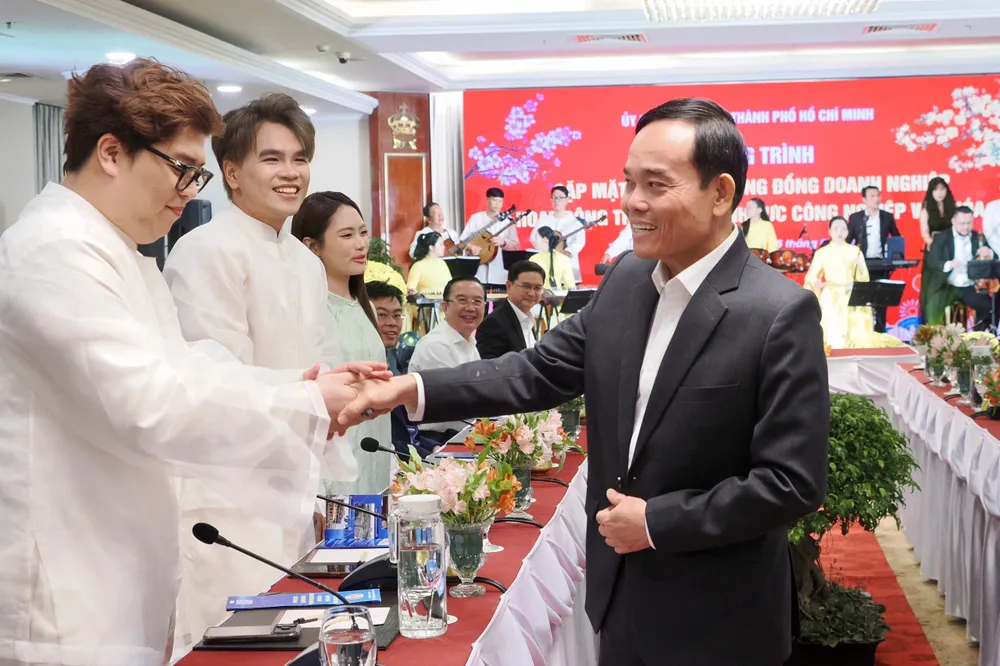 Bí thư Thành ủy TPHCM Trần Lưu Quang bắt tay giao lưu với nhóm sản xuất âm nhạc DTAP tại chương trình Gặp mặt thân mật cộng đồng doanh nghiệp hoạt động trong các lĩnh vực công nghiệp văn hóa do UBND TPHCM.jpg