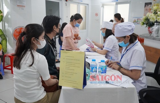 A medical worker is advising a couple to have pre-marital health check-ups to screen A medical worker is advising a couple to have pre-marital health check-ups to screen