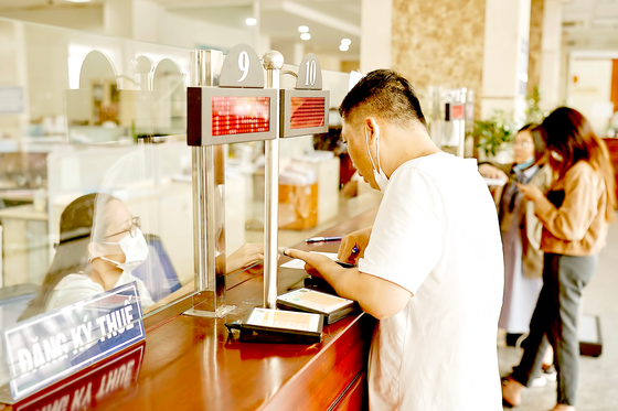 People register to pay tax at a tax agency