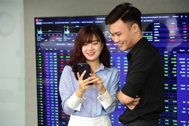 Two investors in front of the e-board showing stocks indices at DSC Securities Co's Trading floor (Photo: DSC)