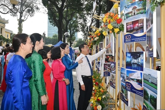 Visitors watch posters of the tourism week