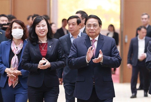 Prime Minister Pham Minh Chinh (right) and Minister of Health Dao Hong Lan attend the national conference on healthcare on Friday. Prime Minister Pham Minh Chinh (right) and Minister of Health Dao Hong Lan attend the national conference on healthcare on Friday.