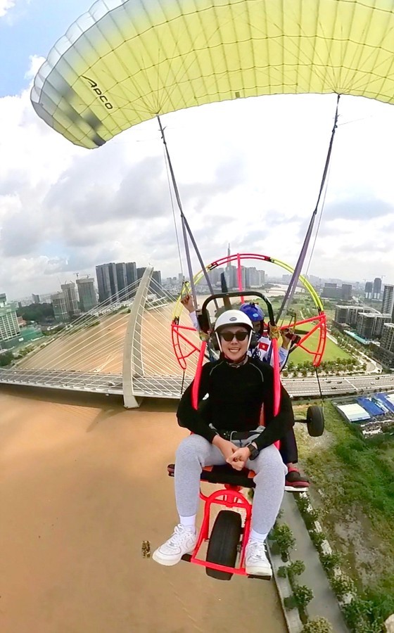 Residents and visitors experience a paragliding flight in the sky