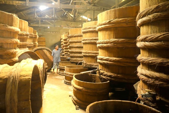 The salt-mixed anchovies are put into wooden barrels for the brewing process