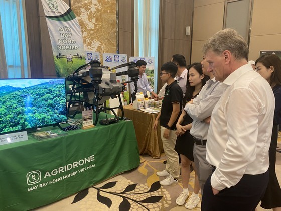 Delegates visit a booth displaying equipment serving agricultural production.