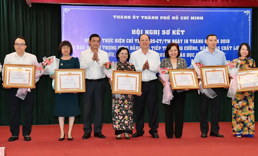 Đồng chí Nguyễn Hồ Hải tặng Bằng khen của Ban Thường vụ Thành ủy TPHCM cho các cá nhân có thành tích xuất sắc trong thực hiện Chỉ thị 20. Ảnh: VIỆT DŨNG