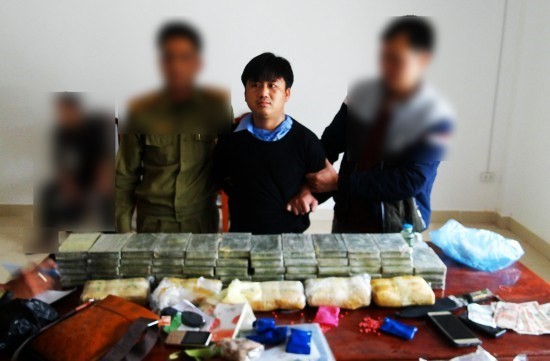 嫌犯楊阿秀(中)與涉案贓物毒品、海洛因及其他物證。（圖源：邊防報）