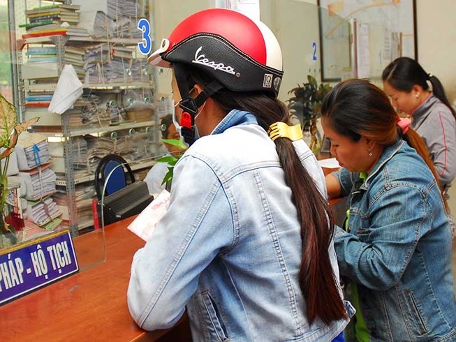 民眾在平政縣平興鄉人委會辦公室辦理戶籍手續。