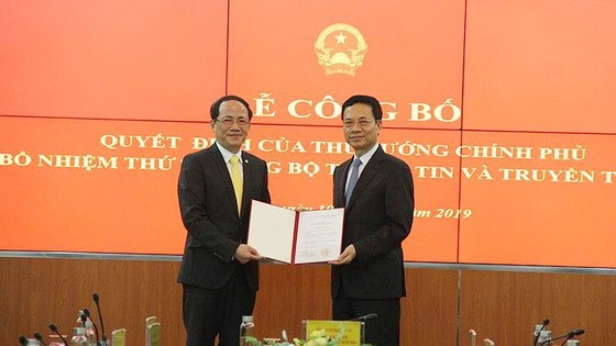 新任新聞與傳播部副部長范英俊（左）從新聞與傳播部部長阮孟雄手中接過人事委任《決定》。（圖源：英黎）