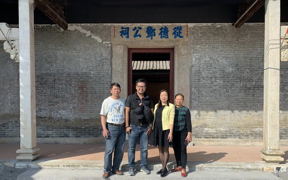 鄧越烽（左二）在故鄉的鄧公祠前與鄉親合影。