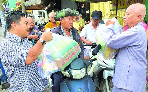 丁文森（左一）與李庭輝代表向窮人派禮物。