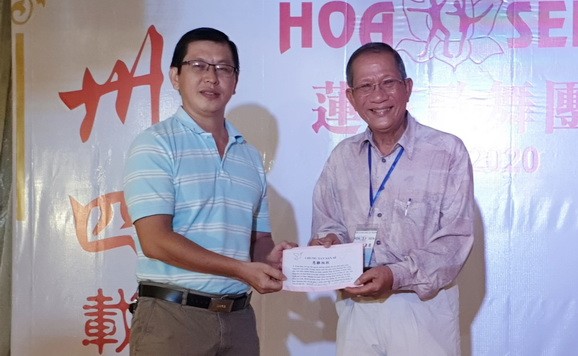 陳志華團長（右）向本報編輯部副主任陳福生轉交善款。