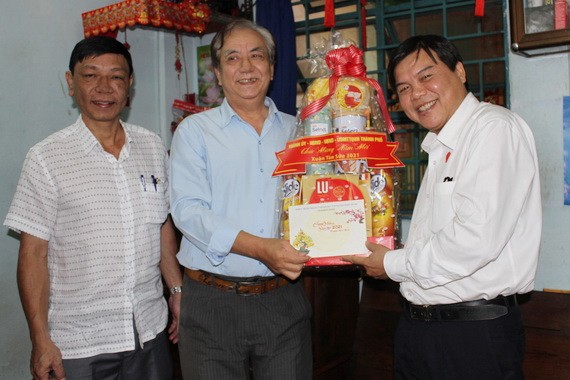 曾友鋒同志（右一）向華人老幹部朱杞文贈送新年禮物。
