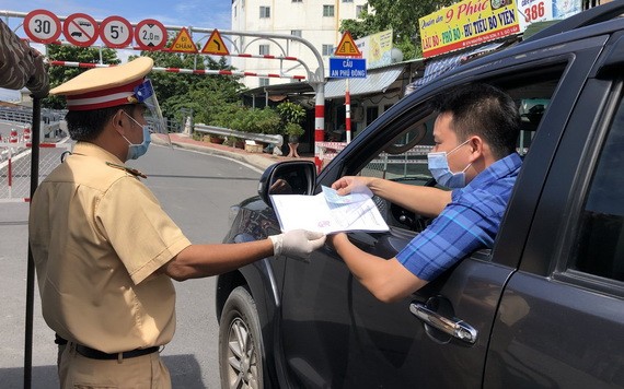 職能力量在新冠疫情防控監察站檢查司機的證件。