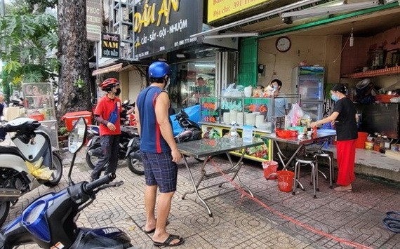 民眾在明記飯館（位於第五郡第八坊陳富街391 號）購買食品。