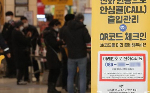 一家大型超市在門口懸掛出示防疫通行證的告示。（圖：韓聯社）