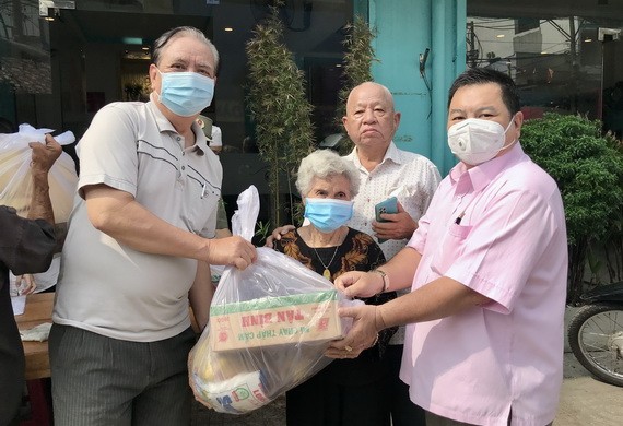 朱杞文先生（左一）、李庭輝（右二）和丁文森（右一）先生向受惠者贈送禮物。