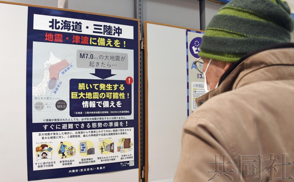 一位老爺在觀看後發地震警惕的疏散避難圖。（圖：共同社）