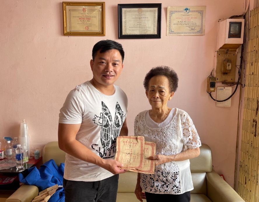 白美兰阿姨（右）向笔者捐赠她与父亲当年捐款建校的收据。