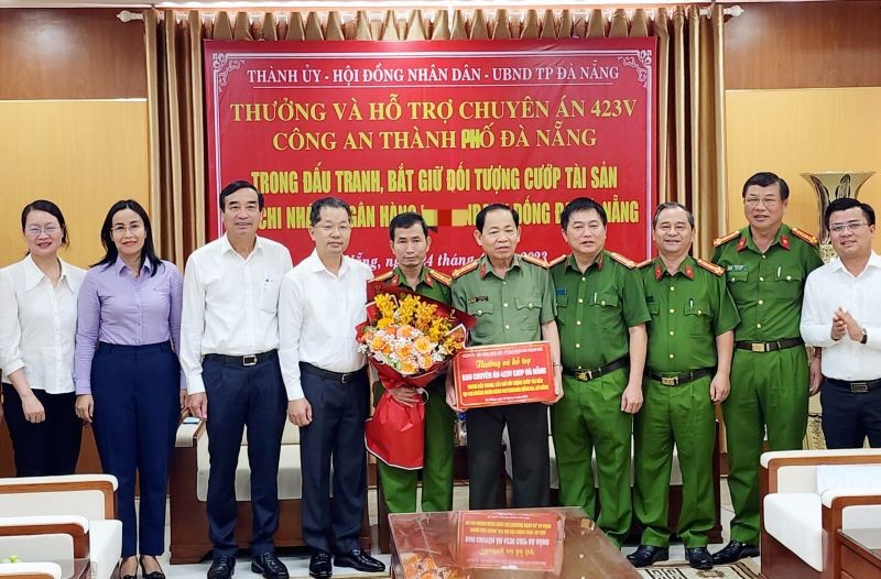 岘港市领导向侦破打劫银行案件的公安力量表彰并合影。（图：人民公安报）