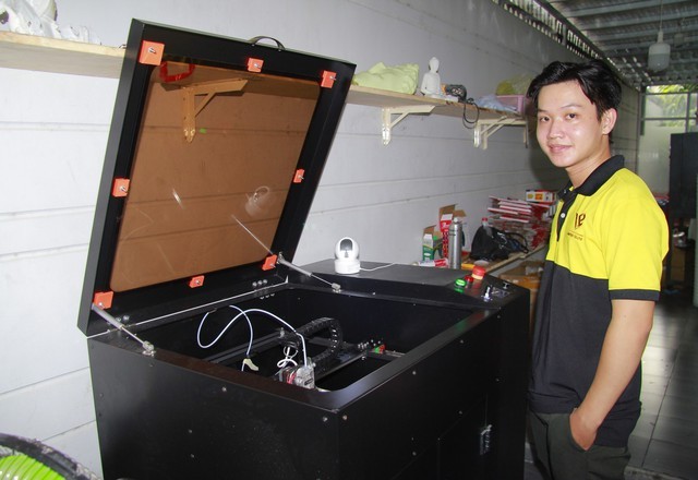 阮文霖与其制造的立体列印机合照。