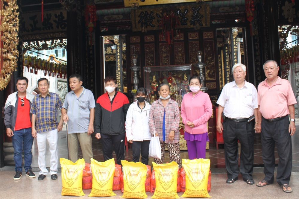 义安会馆理事长陈裕与诸位理事会向贫困乡亲派发盂兰赈济品。