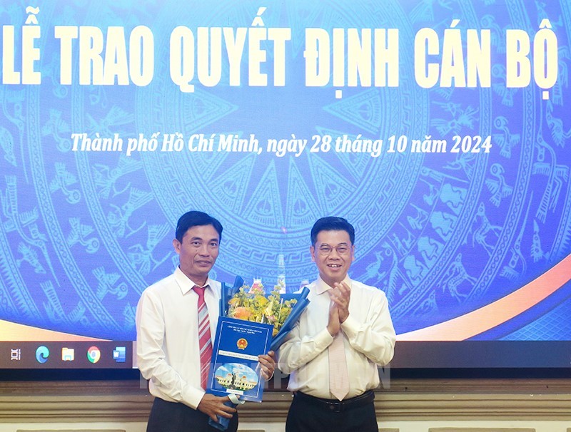 市人委会副主席阮文勇（右）向杜晋竹同志颁授《决定》。（图：市党部新闻网）