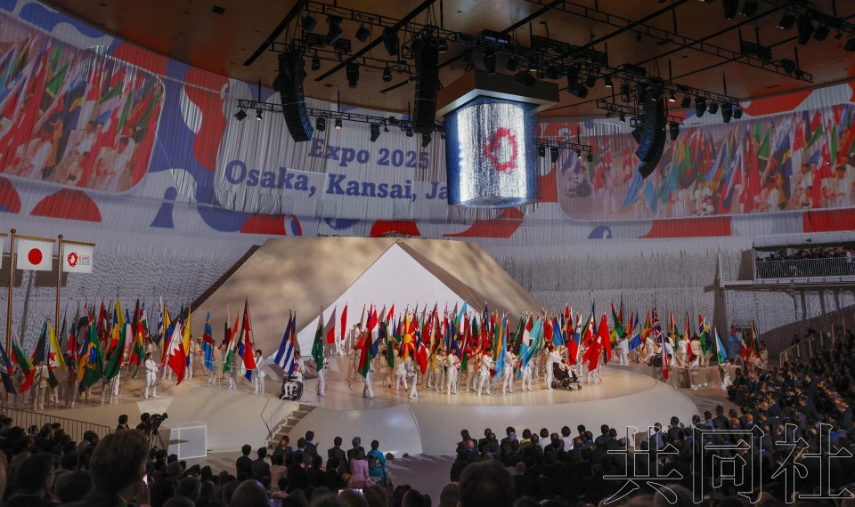 图为大阪·关西世博会开幕式上登场的参展国家和地区、国际机构的旗帜和旗手。4月12日下午摄于大阪市此花区的梦洲。（图：共同社）