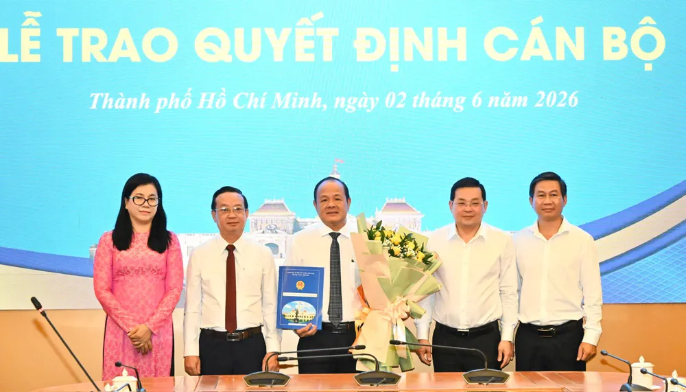 Phó Chủ tịch Bùi Minh Thạnh (thứ 2 từ trái) và Giám đốc Sở NN-MT Nguyễn Toàn Thắng (thứ 2 từ phải) trao quyết định và hoa chúc mừng cho ông Nguyễn Minh Chánh. Ảnh: Việt Dũng