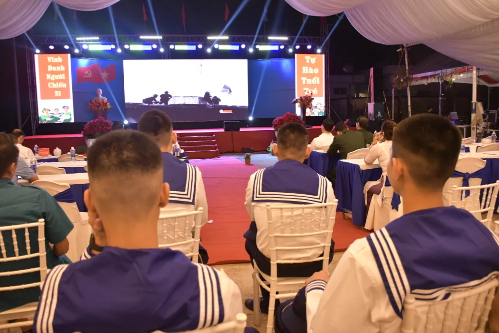 Các thanh niên xem phim tài liệu tại đêm hội tòng quân