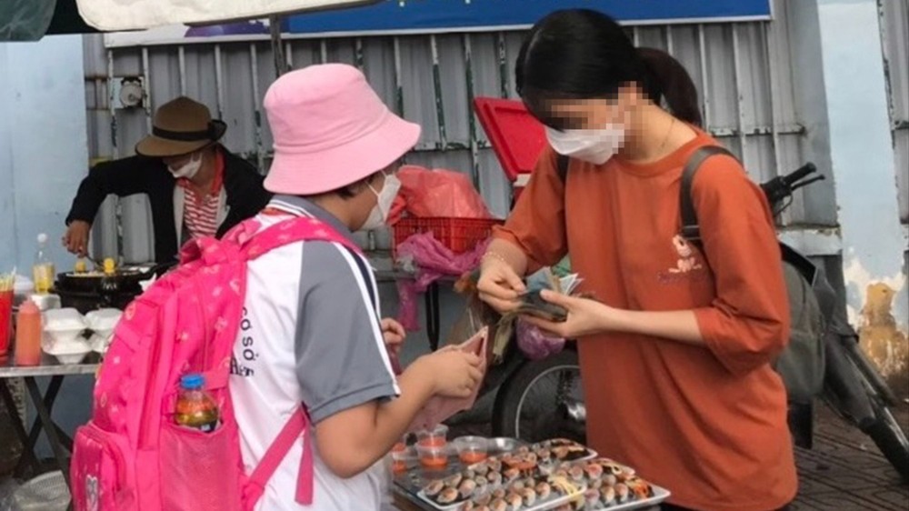  胡志明市一学校门口摆卖的食品车摊。