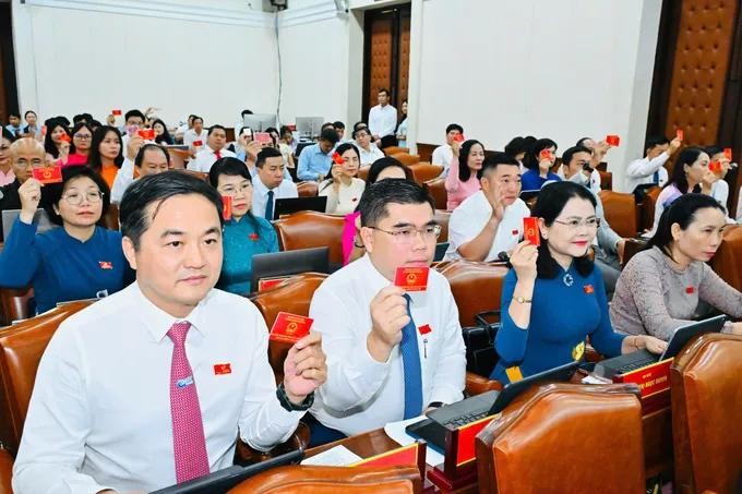 胡志明市人民议会代表在会上表决通过各项《呈文》。