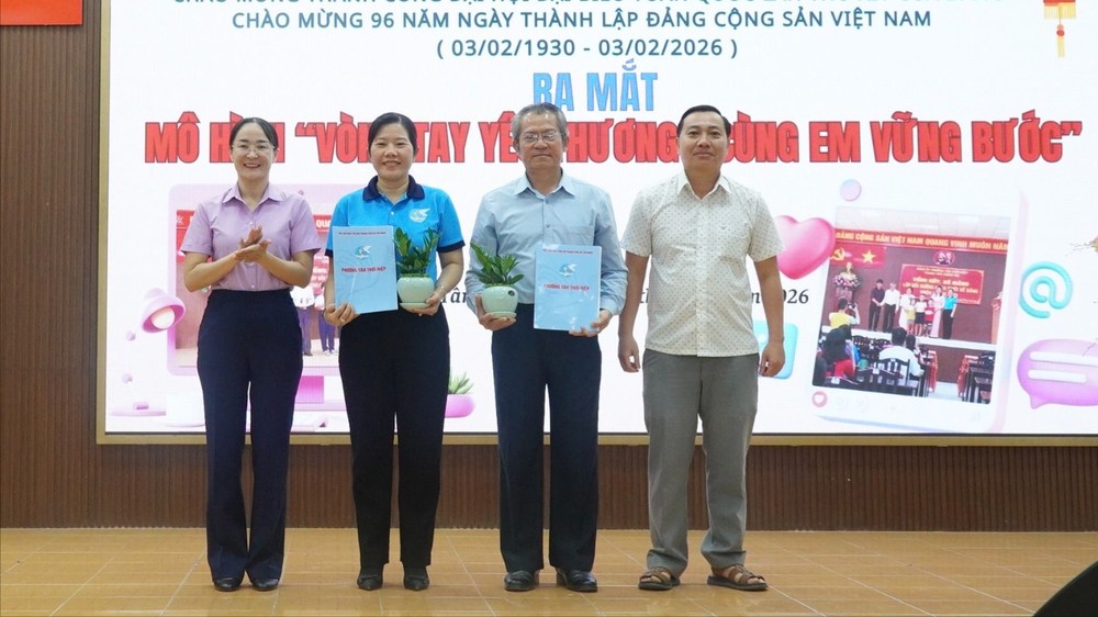 新泰协坊党委常务副书记阮晋力与坊人委会副主席阮氏英诗颁发模式启动决定并赠送盆栽祝贺。