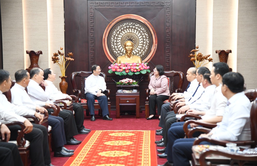 胡志明市市委副书记文氏白雪与阮晋爵主教交谈。