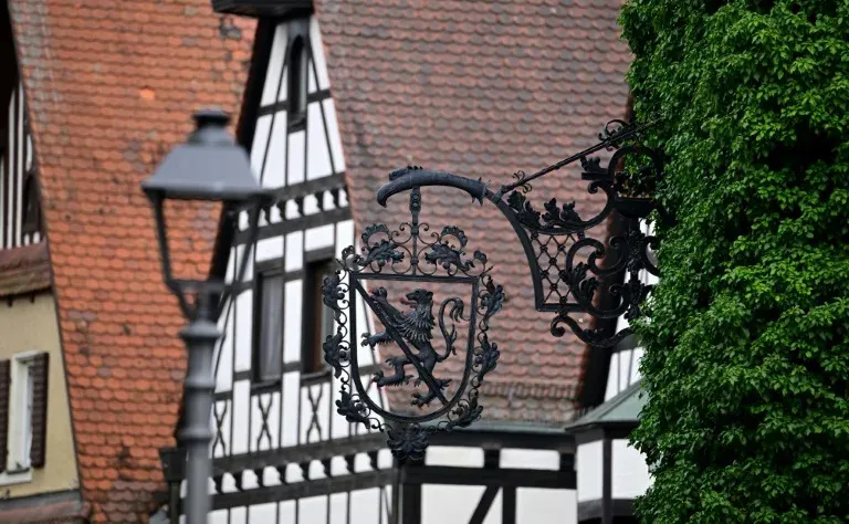 A-sign-with-the-lion_-part-of-the-coat-of-arms-of-Bavaria_-is-seen-on-a-traditional-half-timbered-ho.jpg