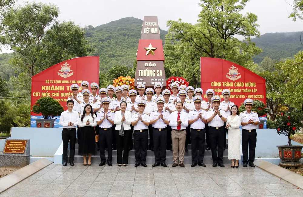 Các đại biểu chụp ảnh lưu niệm bên công trình mô hình cột mốc chủ quyền đảo Trường Sa tại Bộ Tư lệnh Vùng 3 Hải quân