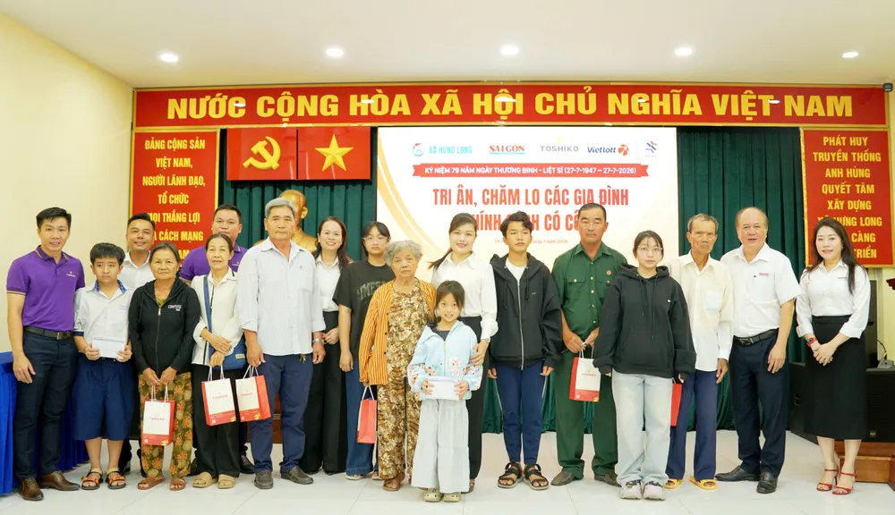 Ban tổ chức trao quà tri ân các gia đình chính sách tại xã Hưng Long. Ảnh: VIỆT NGA