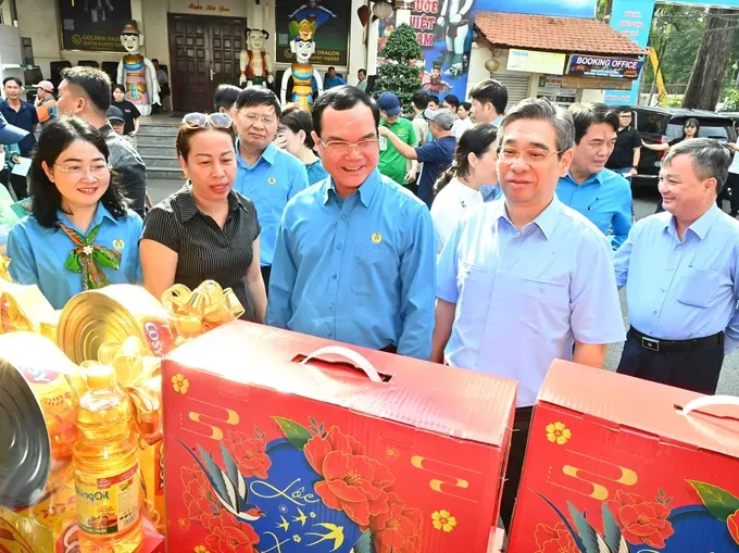 越南劳动总联团主席阮廷康与胡志明市市委副书记阮福禄参观胡志明市"工会春节集市"摊位。