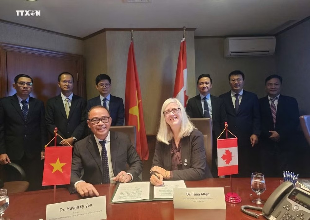 邓德辉副教授（右三）见证特伦特大学与胡志明市资源与环境大学签署合作协议。图：越通社发