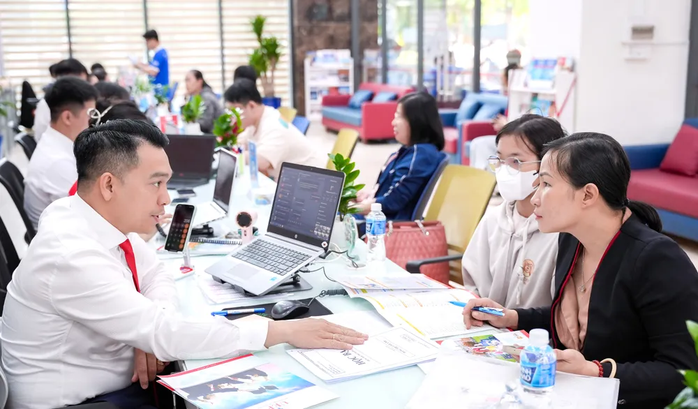 Cán bộ tuyển sinh hướng dẫn phụ huynh, thí sinh nộp hồ sơ dự tuyển bằng điểm học bạ THPT vào Trường ĐH Kinh tế Tài chính TPHCM