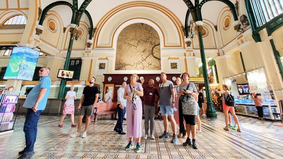 Foreign visitors admiring a period attraction