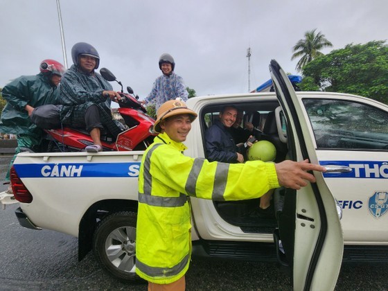 Traffic police transport local residents and two French tourists out from flood-prone area