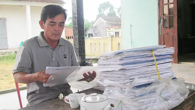 Ngư dân Trần Văn Thanh với chồng hồ sơ gần 3 năm mang gửi  các ngân hàng nhưng đều bị từ chối cho vay