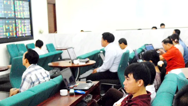 Nhà đầu tư theo dõi giá cổ phiếu tại một công ty chứng khoán                    Ảnh: Cao Thăng