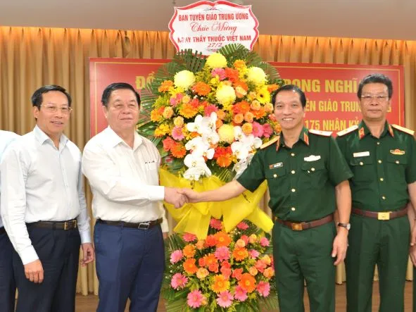 Trưởng Ban Tuyên giáo Trung ương Nguyễn Trọng Nghĩa chúc mừng tập thể cán bộ, nhân viên y tế Bệnh viện Quân y 175. Ảnh: CAO THĂNG