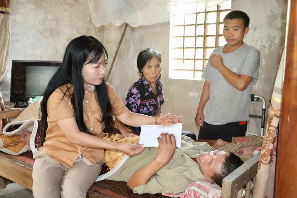 Bà Phan Hồng Yến, Chủ tịch UBND xã Vũ Quang trao 16 triệu đồng của bạn đọc Báo SGGP hỗ trợ gia đình ông Phạm Văn Hiển