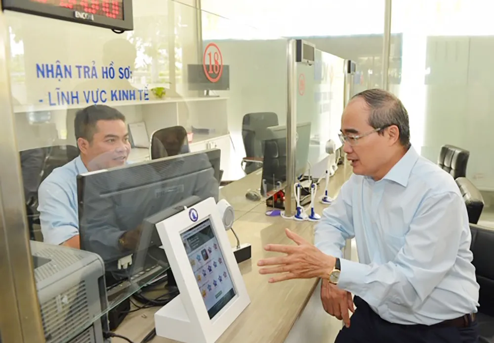 Bí thư Thành ủy TPHCM Nguyễn Thiện Nhân trao đổi  cùng cán bộ quận 12 về cải cách thủ tục hành chính. Ảnh: VIỆT DŨNG