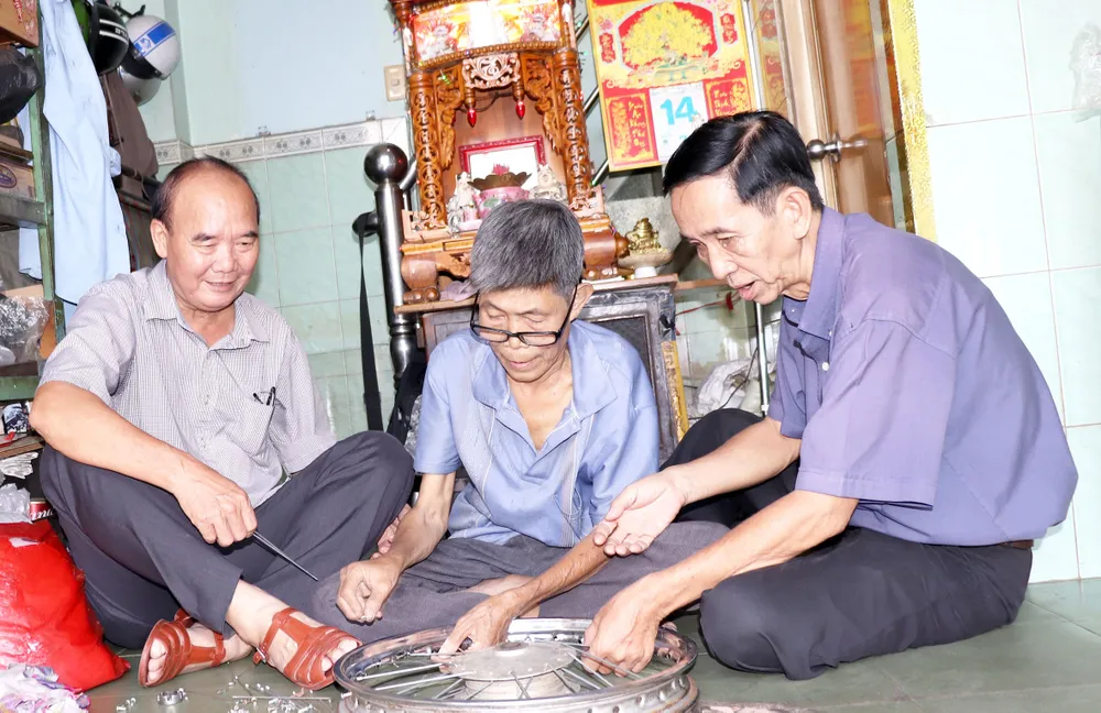 Ông Nguyễn Văn Sướng (trái) luôn có nhiều cách làm hay chăm lo  đồng đội và người dân. Ảnh:  THÁI PHƯƠNG