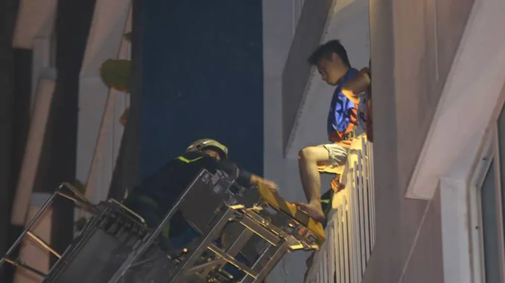 Lực luợng phòng cháy chữa cháy dùng thang giải cứu người mắc kẹt ở các tầng trên. Ảnh: DŨNG PHƯƠNG