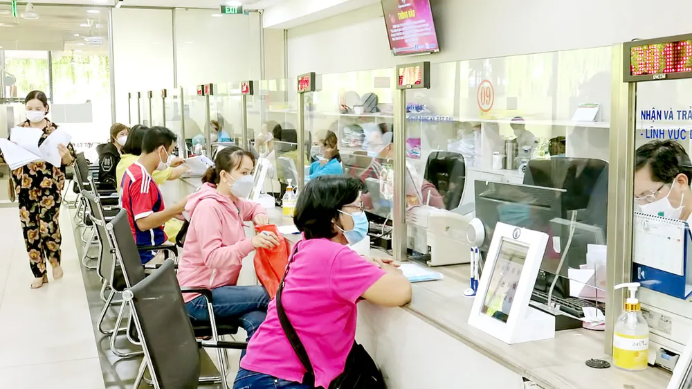 Tiếp nhận, giải quyết hồ sơ tại quận 12. Ảnh: MINH NGHĨA